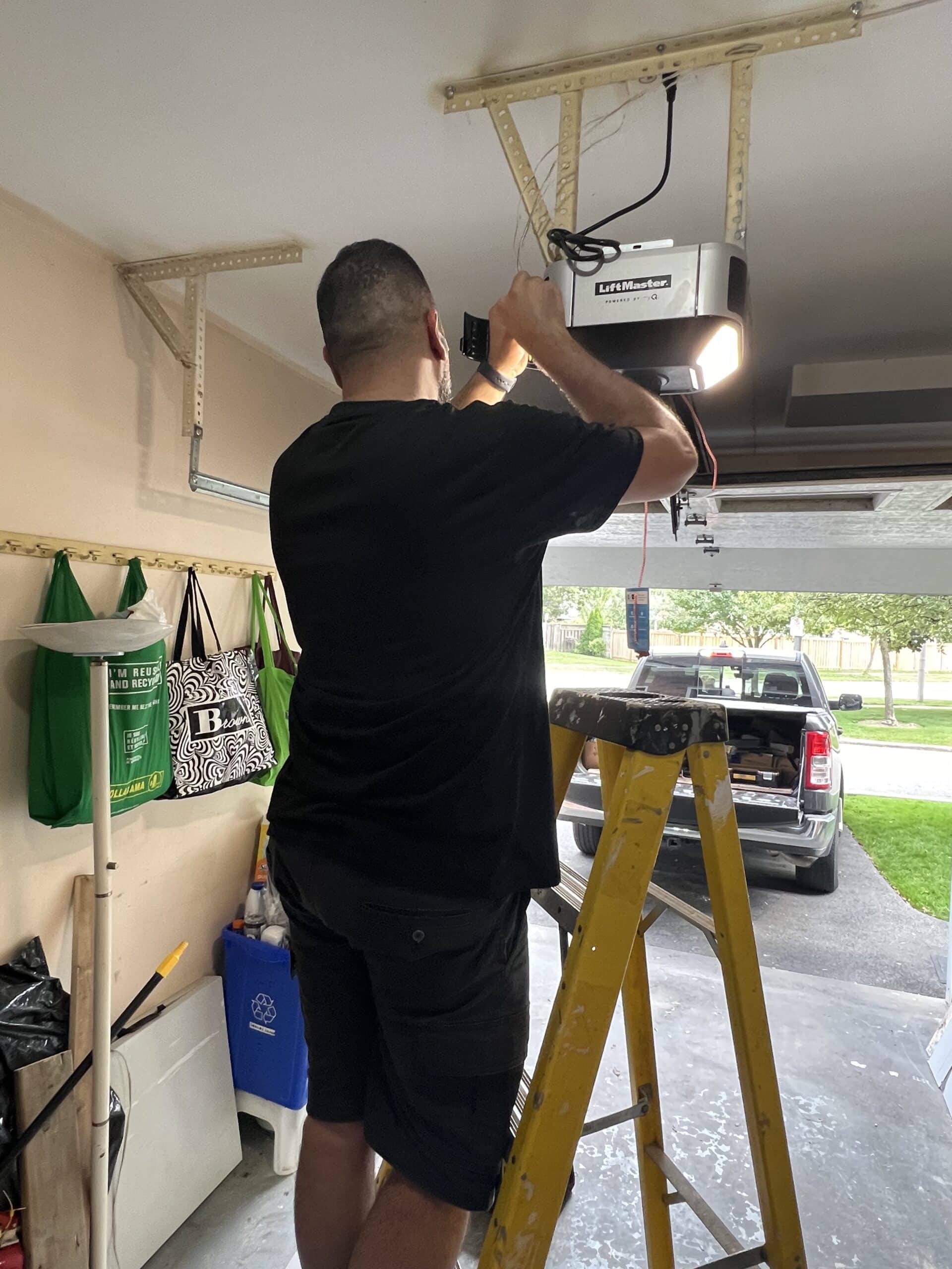 Technician repairing garage door opener